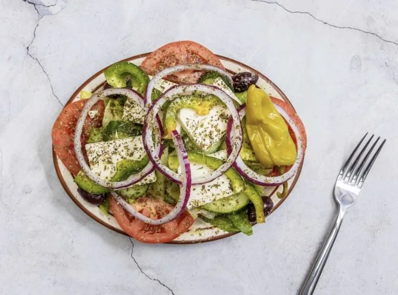 Horiatiki salad: tomatoes, cucumbers, onions, peppers, olives and feta